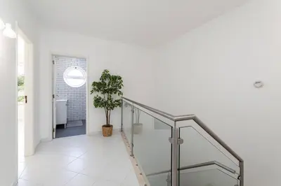 a white bedroom with two beds and a window at The Albufeira Concierge - Casa IÊ in Albufeira