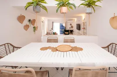 a white dining room table with a cookie on it at Windmill by OCvillas in Albufeira