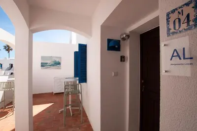 a room with a door and a table and chairs at Windmill by OCvillas in Albufeira