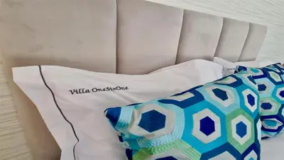 a white bed with two pillows on top of it at OneSixOne-Cleverdetails, Luxury villa, Sleeps 8 adults 2 children, Private pool and Jacuzzi in Vilamoura