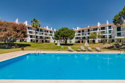 a large swimming pool in front of a building at AL - Apartamento Vila Sol Village in Cabeço de Câmara