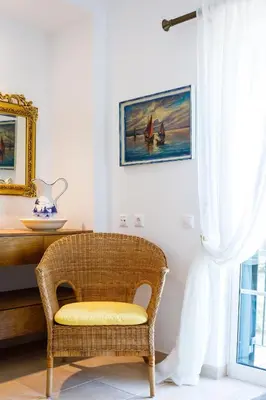 a chair in a room with a table and a window at Falésia Ocean Villa by The Portuguese Butler in Albufeira