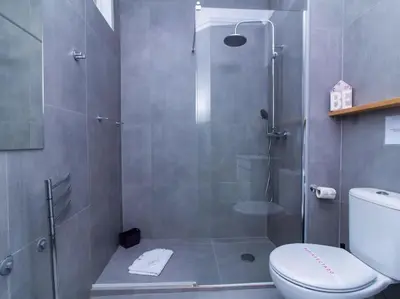 a bathroom with a glass shower with a toilet at Sea View Studio by Stay ici Algarve Holiday Rental in Albufeira