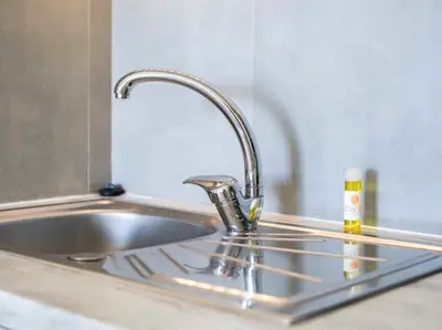 a sink with a faucet in a kitchen at Sea View Studio by Stay ici Algarve Holiday Rental in Albufeira
