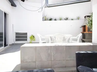 a patio with white chairs and a table at Old Town II Apartment by Stay ici Algarve Holiday Rental in Albufeira