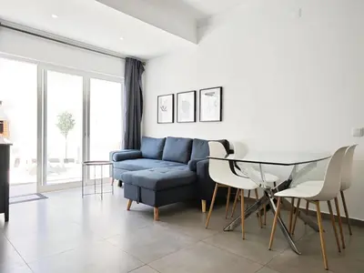 a living room with a blue couch and a table at Old Town II Apartment by Stay ici Algarve Holiday Rental in Albufeira