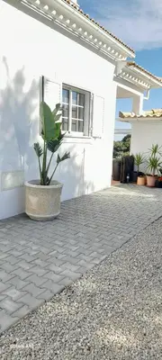 a swimming pool in front of a house at Green Ville in Faro