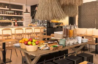 a table with baskets of fruit on it in a restaurant at Apartamentos Baltum in Albufeira