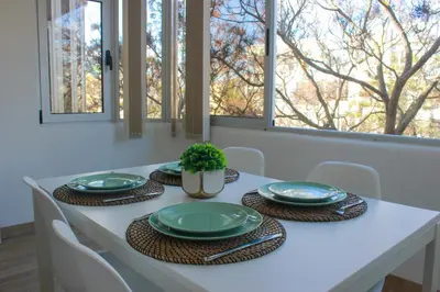 a kitchen with white cabinets and a sink and a window at Solbelo Quarteira Beach in Quarteira