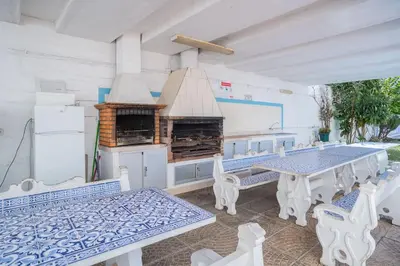 a bedroom with a large white bed with towels on it at Solbelo Quarteira Beach in Quarteira