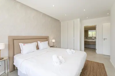 a bedroom with a large white bed with white pillows at Hopstays - Vila das Lagoas - Salgados in Albufeira