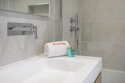 a bathroom with a white sink with a towel at Hopstays - Vila das Lagoas - Salgados in Albufeira