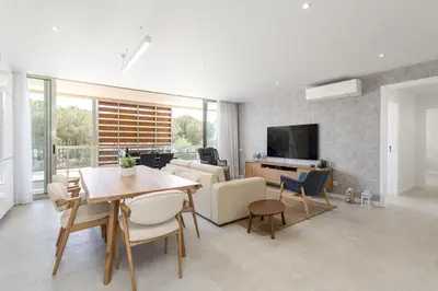 a living room with a table and chairs and a television at Hopstays - Vila das Lagoas - Salgados in Albufeira