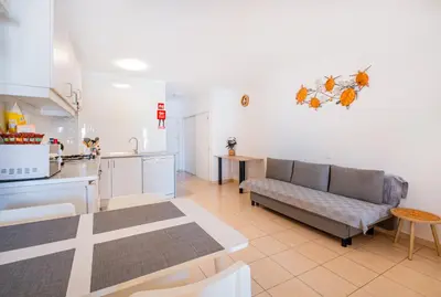 a living room with a couch and a kitchen at Beach Studio in Albufeira's old town in Albufeira