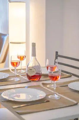 a bottle of wine sitting on a table with wine glasses at Beach Studio in Albufeira's old town in Albufeira