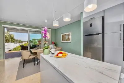 a kitchen with a counter with fruit on a cutting board at Luxury Villa in Serene Location with Pool & Private Garden in Quarteira