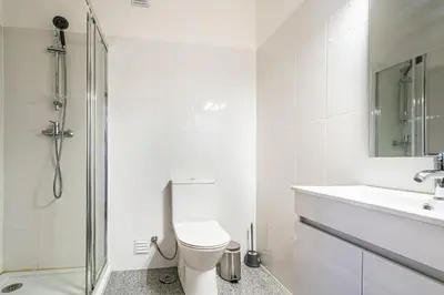 a white bathroom with a toilet and a sink at BeGuest Albufeira Visconde Apartment in Albufeira