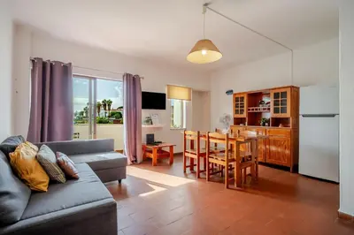 a living room with a couch and a table at BeGuest Albufeira Visconde Apartment in Albufeira