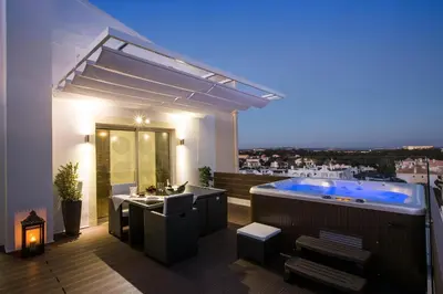 a bathroom with a hot tub on a roof at D_Loft in Albufeira