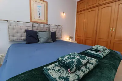 a bedroom with a blue bed with two pillows on it at Villa Jóia - 3 Bedroom Villa with Swimming pool in Boliqueime, near Vilamoura, Algarve in Boliqueime