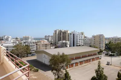 a large building in a city with tall buildings at Sunset House Algarve in Faro