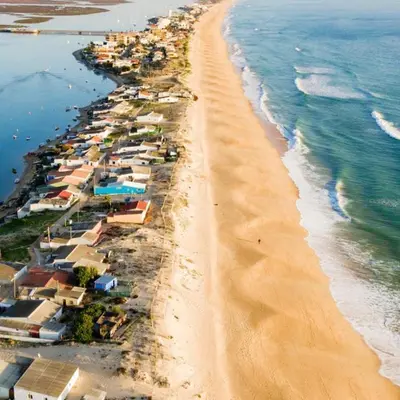 an aerial view of a beach with houses and the ocean at Sunset House Algarve in Faro