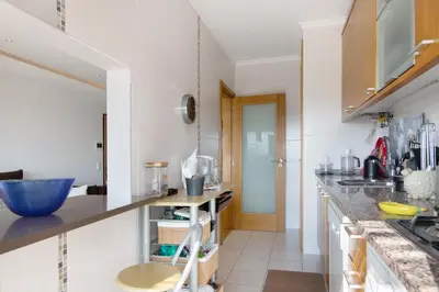 a kitchen with white walls and a counter top at Sunset House Algarve in Faro