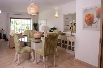 a dining room with a table and chairs at Vila Rosal Margarida Apartment in Albufeira