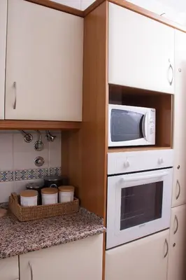 a small kitchen with a microwave and a counter at Vila Rosal Margarida Apartment in Albufeira