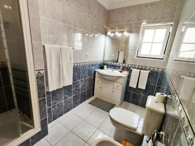a bathroom with a toilet and a sink and a shower at Vila Rosal Margarida Apartment in Albufeira
