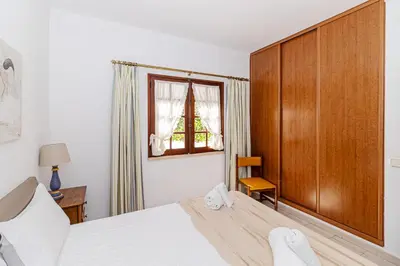 a bedroom with a large bed and a window at Villa Fineli in Vilamoura