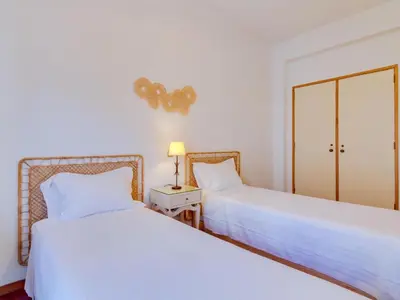 two beds sitting next to each other in a bedroom at AL - Apartamento Maré Alta in Quarteira