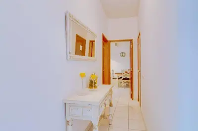 a room with a table and a mirror on the wall at Nascente Sea View @Homesbyfc in Quarteira