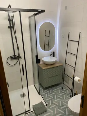 a bathroom with a sink and a mirror at Apartamento Flor de Amendoeira in Albufeira