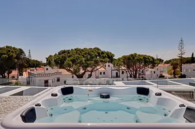 a bath tub sitting on top of a house at One Six Villa in Vilamoura