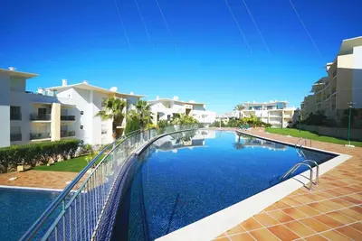 a swimming pool with a metal fence around it at AlbufeiraOrada Garden by Be Cherish in Albufeira