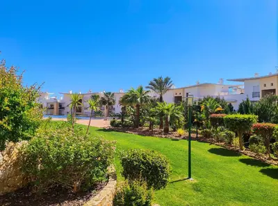 a park with grass and trees and buildings at AlbufeiraOrada Garden by Be Cherish in Albufeira