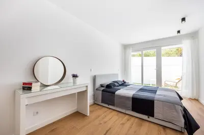 a bedroom with a bed and a mirror and a desk at Alfamar Inês Apartment in Albufeira