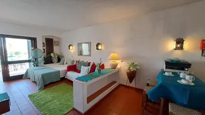 a living room with a bed and a couch at ALBUFEIRA TRADICIONAL BEACH APARTMENT in Albufeira