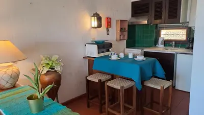 a kitchen with a blue table and some chairs at ALBUFEIRA TRADICIONAL BEACH APARTMENT in Albufeira