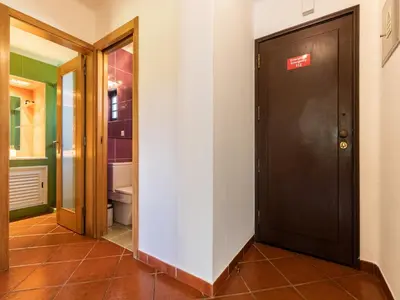 a hallway with a brown door and a bathroom at Akivillas Albufeira Felicity in Albufeira