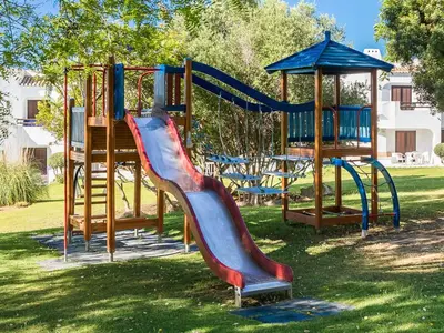 a playground with a slide in a park at Akivillas Albufeira Felicity in Albufeira