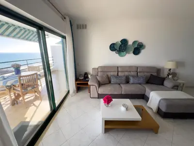 a living room with a couch and a table at Ocean Blue II in Quarteira