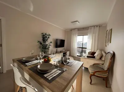 a living room with a table with wine glasses on it at Falésia Beach Apartment in Albufeira