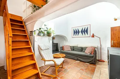 a living room with a staircase and a couch at BeGuest Casa Romãzeira Typical Vila in Goncinha