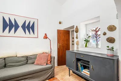 a living room with a couch and a table at BeGuest Casa Romãzeira Typical Vila in Goncinha