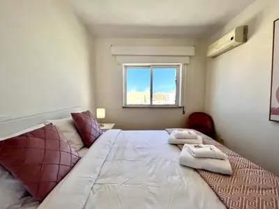 a bedroom with a large bed with two towels on it at Faro Rising by Homing in Faro