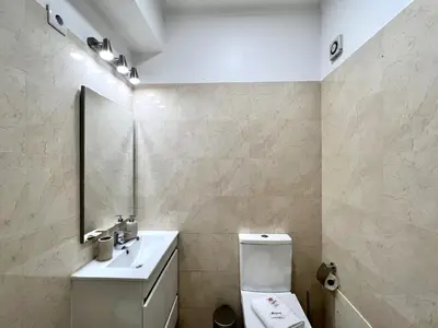 a bathroom with a toilet and a sink and a mirror at Faro Rising by Homing in Faro