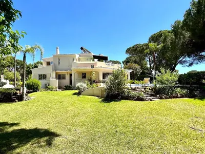 a large white house with a large yard at Vilamoura Amazing Golf Villa With Pool by Homing in Vilamoura