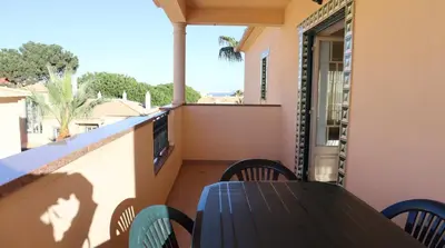 a table and chairs on a balcony with a view at Bicos Beach Apartments By Albufeira Rental in Albufeira